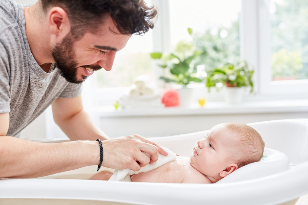 Baby badet mit Papa